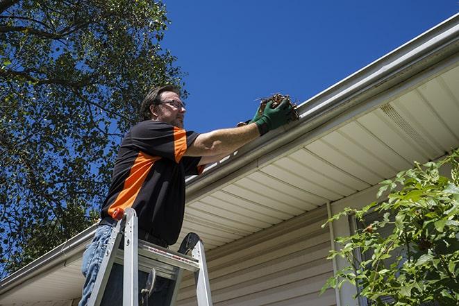 gutter repair technician using a power drill in Ardmore