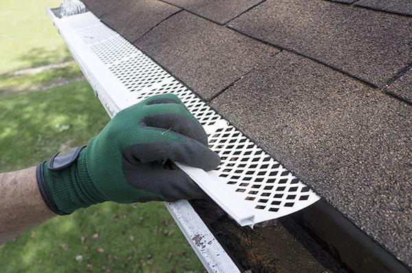 installing gutter guards can prevent clogs, improve water flow, and reduce the need for frequent gutter cleaning